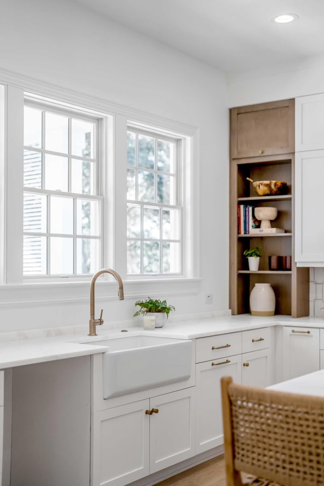 kitchen featuring sink and white cabinets