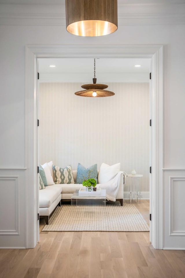 unfurnished room featuring ornamental molding and light wood-type flooring