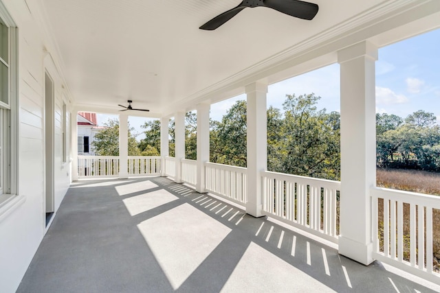 unfurnished sunroom with ceiling fan