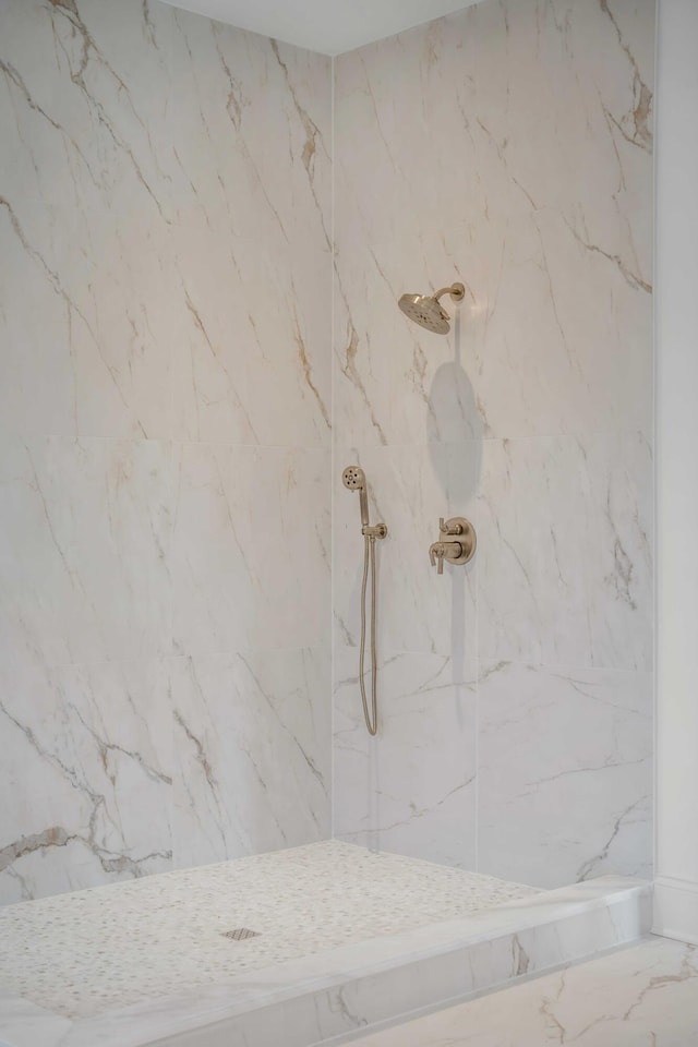 bathroom with a tile shower