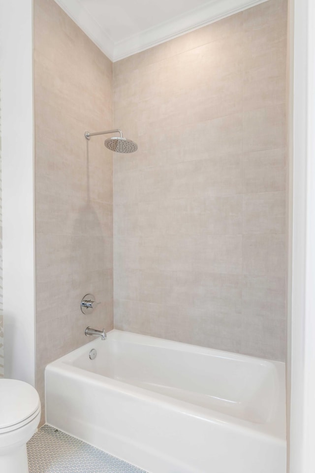 bathroom featuring tile patterned flooring, crown molding, tiled shower / bath, and toilet