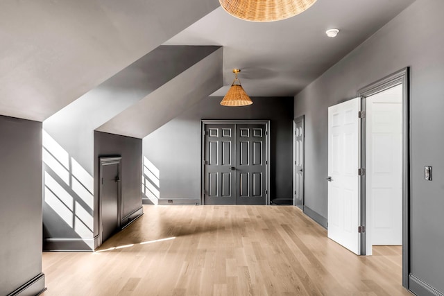 entrance foyer featuring a baseboard heating unit and light wood-type flooring