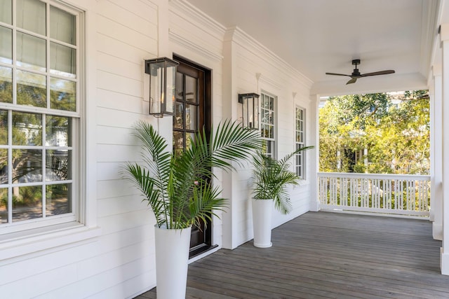 wooden deck featuring ceiling fan and covered porch