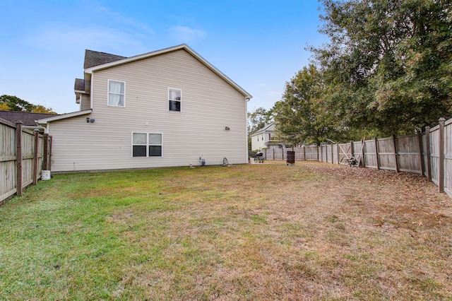 rear view of house with a yard