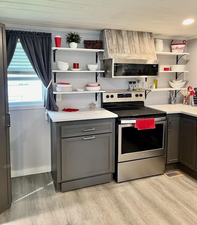 kitchen with open shelves, backsplash, gray cabinets, light wood-style flooring, and appliances with stainless steel finishes