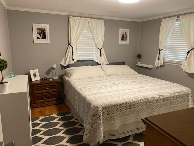 bedroom featuring crown molding, multiple windows, and dark wood-style flooring