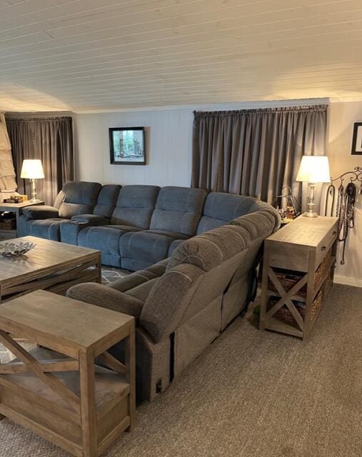 living area with wooden ceiling and carpet floors