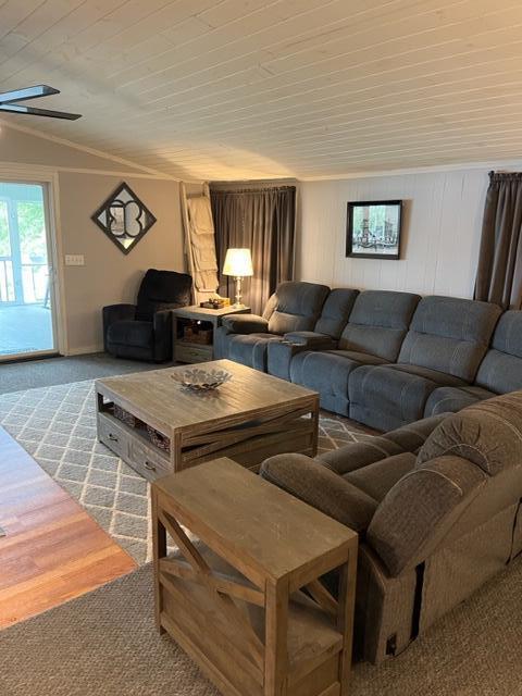 carpeted living room with wood ceiling and ceiling fan