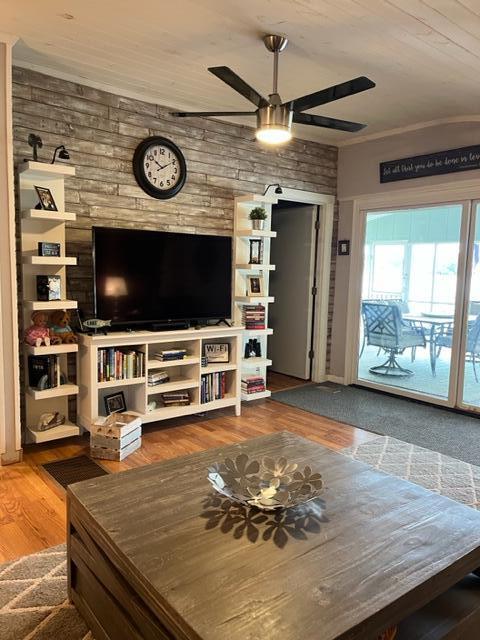 living area featuring wood finished floors and ceiling fan