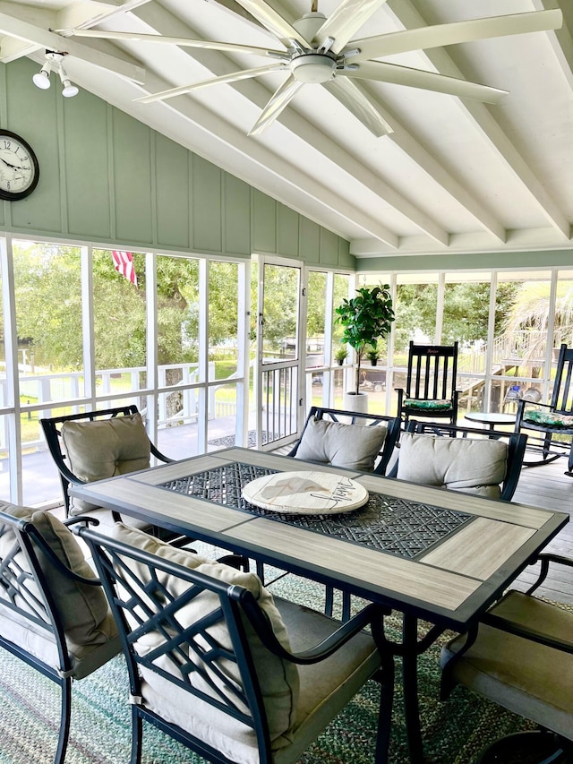 sunroom / solarium with beamed ceiling, outdoor dining space, and ceiling fan