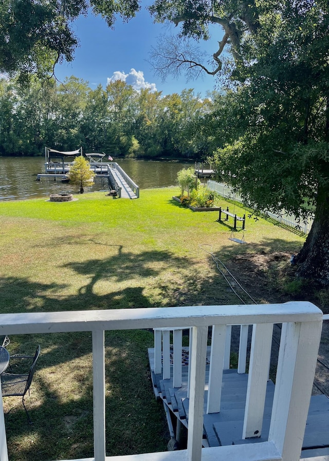 dock area with a yard and a water view