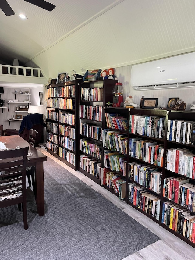 home office with a wall mounted AC, wall of books, recessed lighting, and ceiling fan