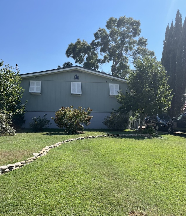 view of side of property with a yard