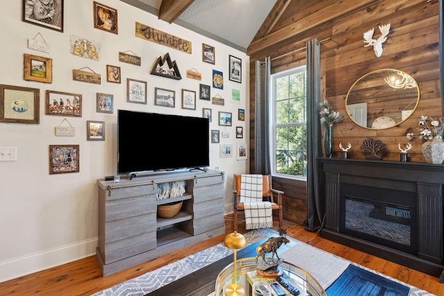 living room with lofted ceiling with beams and wood-type flooring