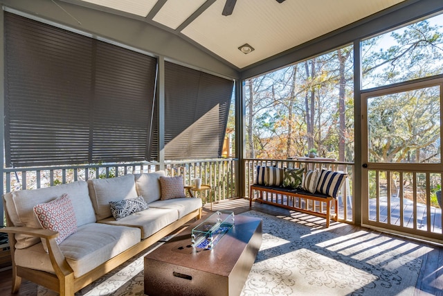 sunroom with ceiling fan and vaulted ceiling