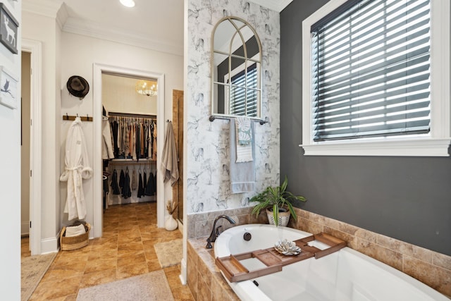 bathroom featuring ornamental molding, a chandelier, tiled tub, and plenty of natural light