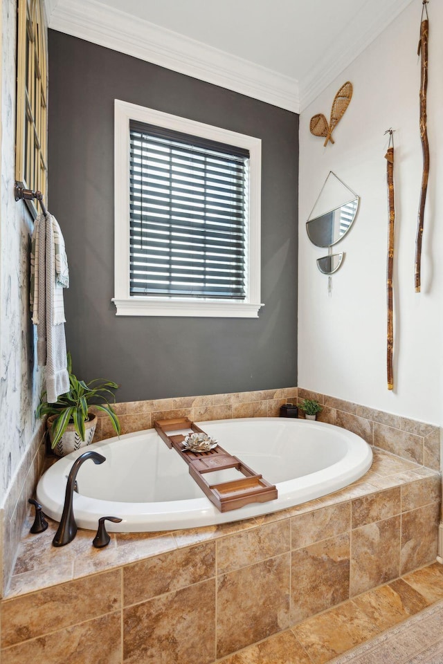 bathroom featuring ornamental molding and tiled tub