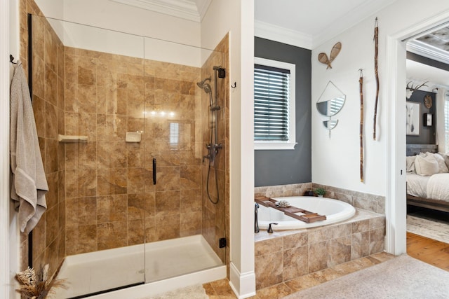 bathroom featuring ornamental molding and shower with separate bathtub