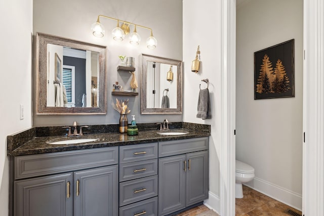 bathroom featuring vanity, tile patterned floors, and toilet