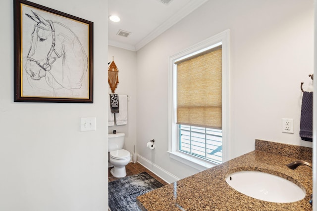 bathroom with toilet, vanity, tile patterned flooring, and crown molding