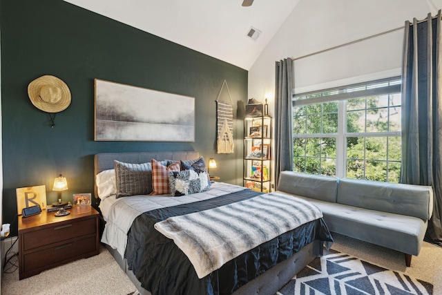 carpeted bedroom with high vaulted ceiling and ceiling fan