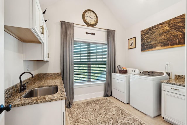 washroom with sink, cabinets, light tile patterned flooring, and independent washer and dryer