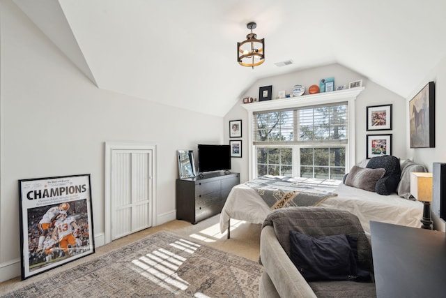 bedroom featuring light carpet and lofted ceiling