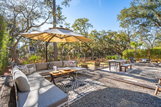 view of patio with an outdoor living space with a fire pit