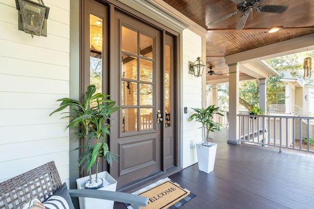 entrance to property with a porch and ceiling fan