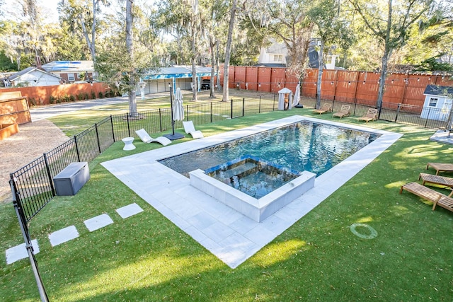 view of pool with a lawn, fence, and a pool with connected hot tub