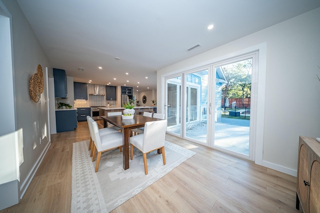 dining room with light wood-type flooring, visible vents, baseboards, and recessed lighting