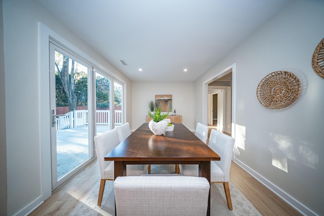 dining area with light wood-style floors, recessed lighting, visible vents, and baseboards