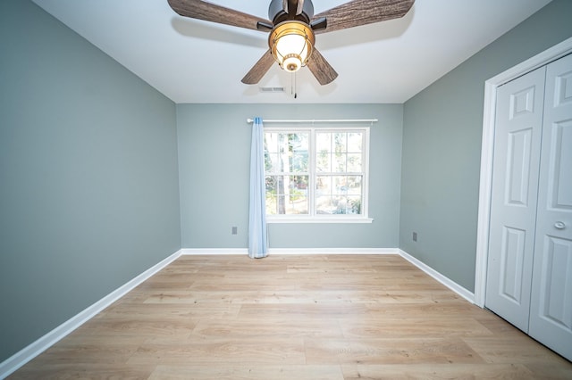 unfurnished bedroom with light wood-style flooring, visible vents, baseboards, and ceiling fan