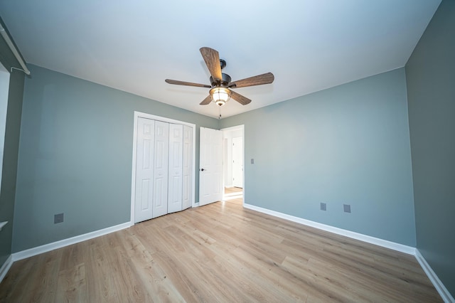 unfurnished bedroom featuring light wood finished floors, a closet, a ceiling fan, and baseboards