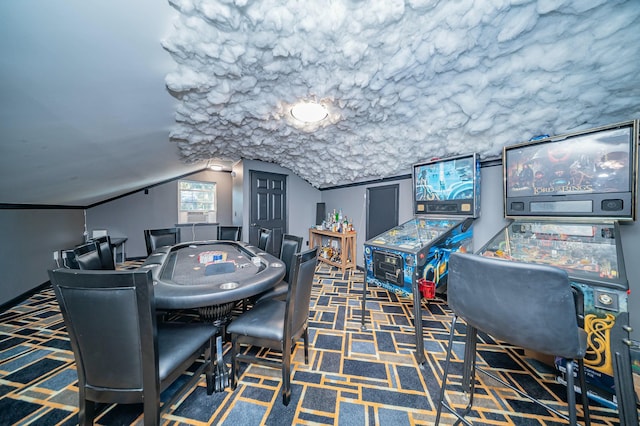 playroom featuring vaulted ceiling and dark colored carpet