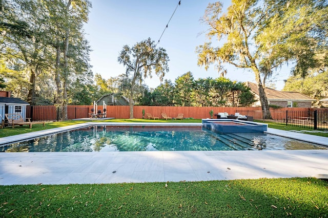 view of swimming pool featuring a fenced backyard and a pool with connected hot tub