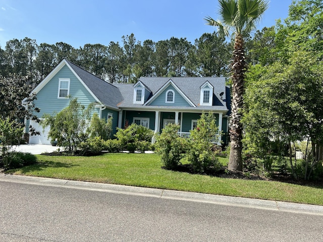 cape cod-style house featuring an attached garage, a porch, and a front yard