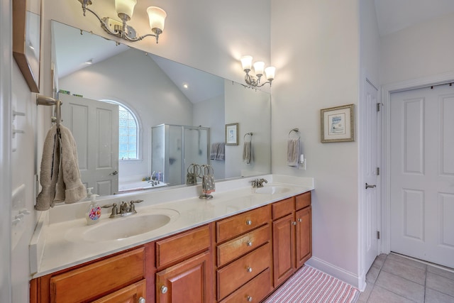 bathroom with a sink, tile patterned floors, and a notable chandelier