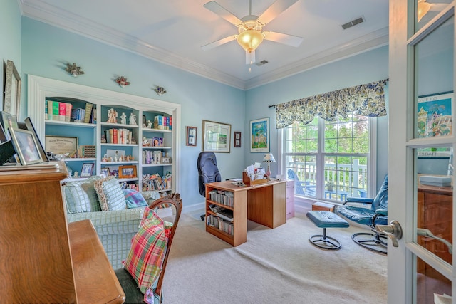 carpeted office space with crown molding, ceiling fan, and visible vents