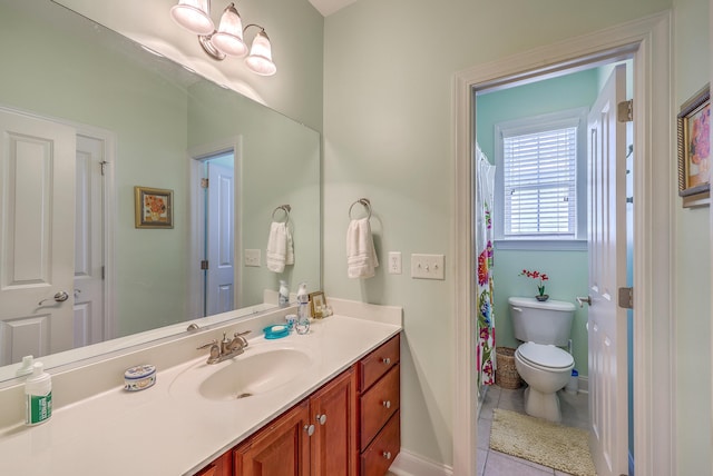 bathroom with vanity, tile patterned floors, baseboards, and toilet