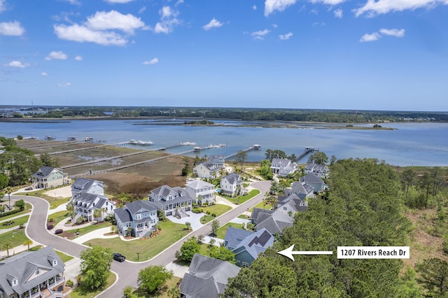 drone / aerial view featuring a residential view and a water view