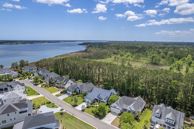 birds eye view of property featuring a water view, a view of trees, and a residential view