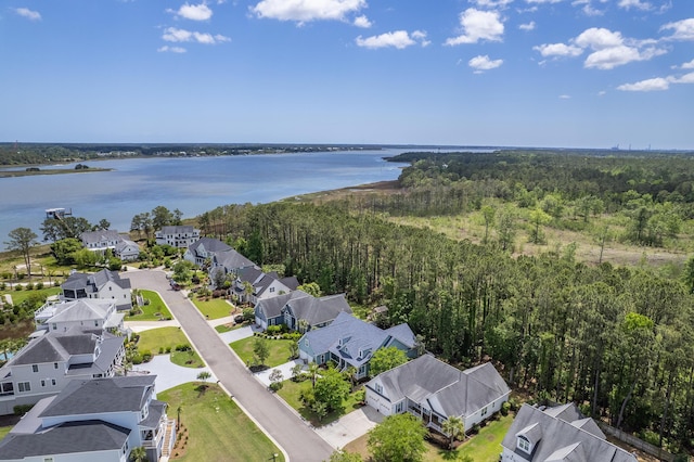 aerial view featuring a water view, a view of trees, and a residential view
