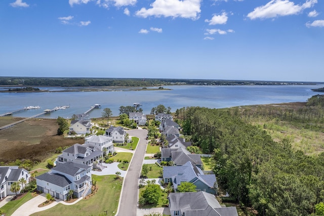 birds eye view of property with a water view and a residential view