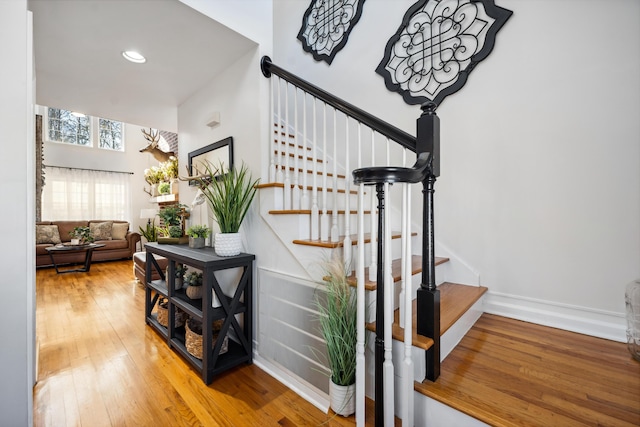 stairs featuring hardwood / wood-style flooring