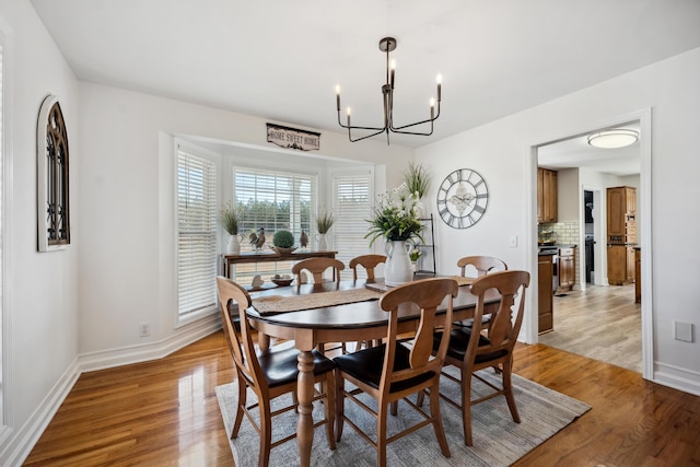 dining room featuring an inviting chandelier and light hardwood / wood-style floors