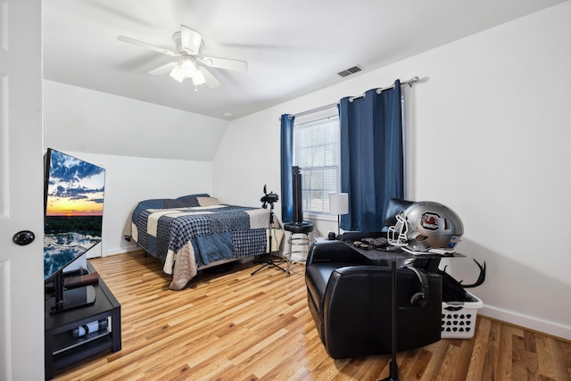 bedroom with vaulted ceiling, ceiling fan, and hardwood / wood-style floors