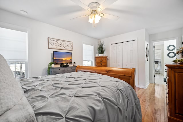 bedroom featuring light hardwood / wood-style floors, a closet, and ceiling fan
