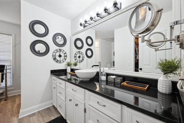 bathroom with vanity, a wealth of natural light, and hardwood / wood-style floors