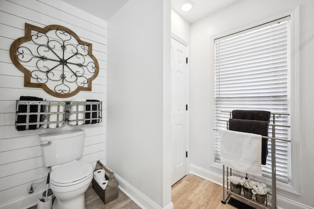bathroom with wood-type flooring and toilet